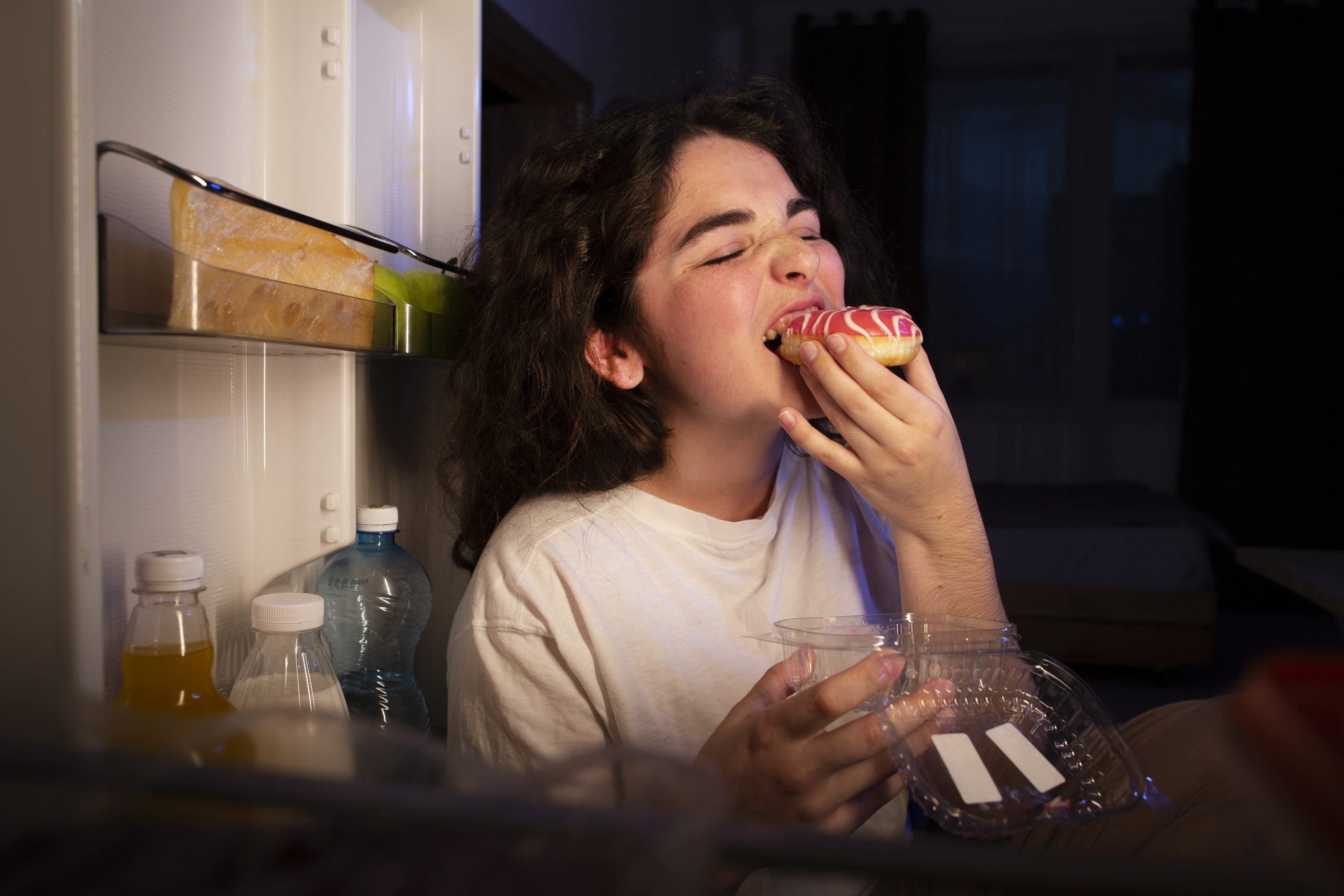 side-view-woman-eating-doughnut